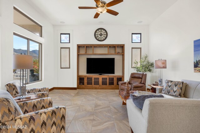 living room featuring ceiling fan and light tile patterned floors