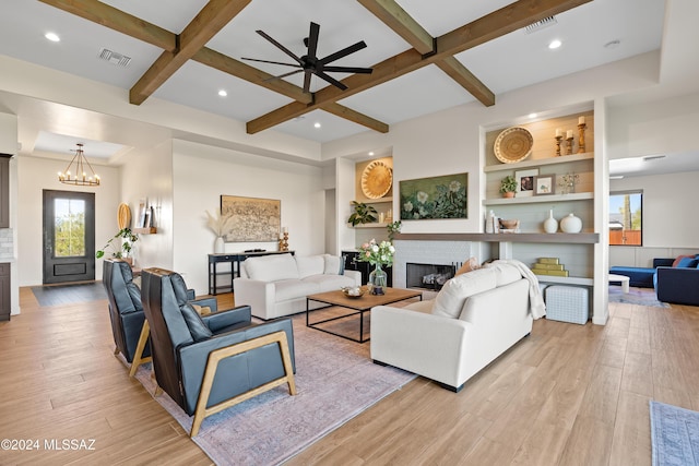 living area with a fireplace, visible vents, light wood-style flooring, coffered ceiling, and beamed ceiling