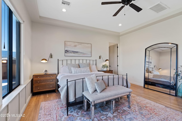 bedroom with light wood-style flooring, visible vents, and recessed lighting