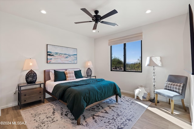 bedroom featuring recessed lighting, light wood-style flooring, and baseboards