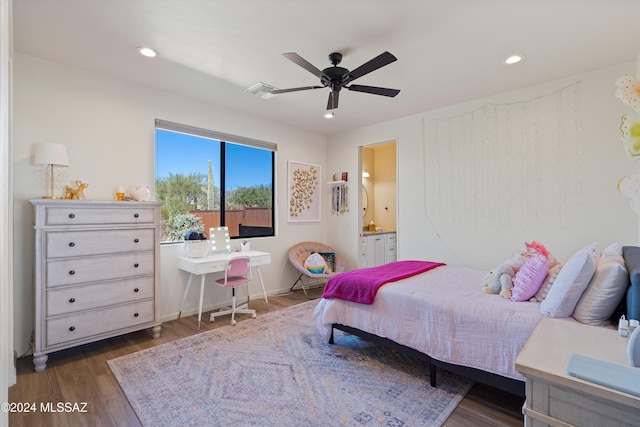 bedroom featuring dark hardwood / wood-style floors, ensuite bath, and ceiling fan