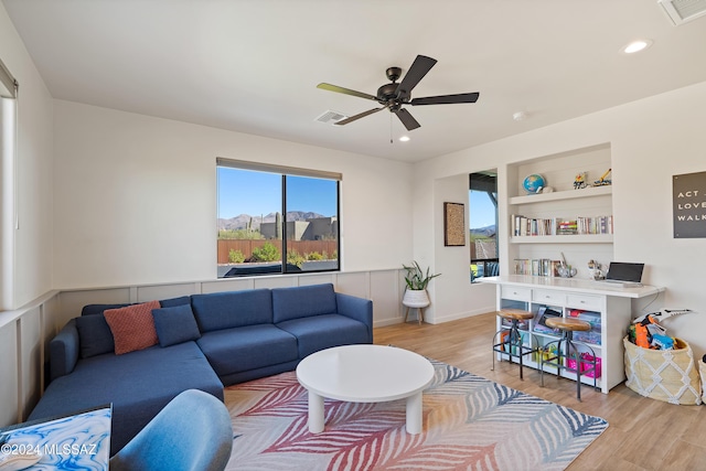 living room featuring recessed lighting, visible vents, and light wood-style flooring