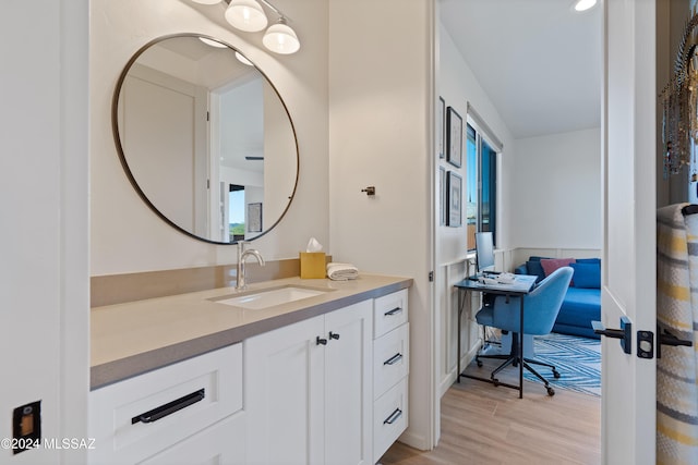 bathroom with wood finished floors and vanity