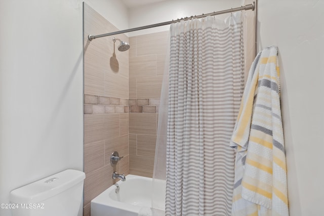 bathroom featuring shower / bath combo and toilet