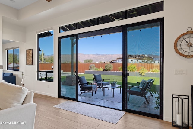 doorway to outside with a mountain view and light hardwood / wood-style floors