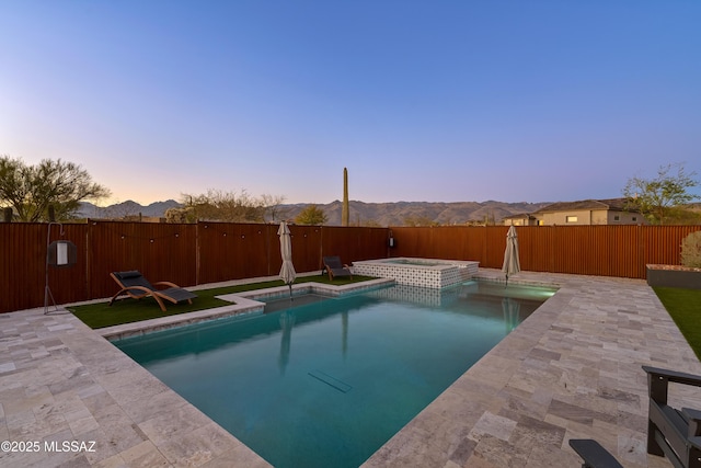 view of pool with a patio area, a fenced backyard, a fenced in pool, and an in ground hot tub