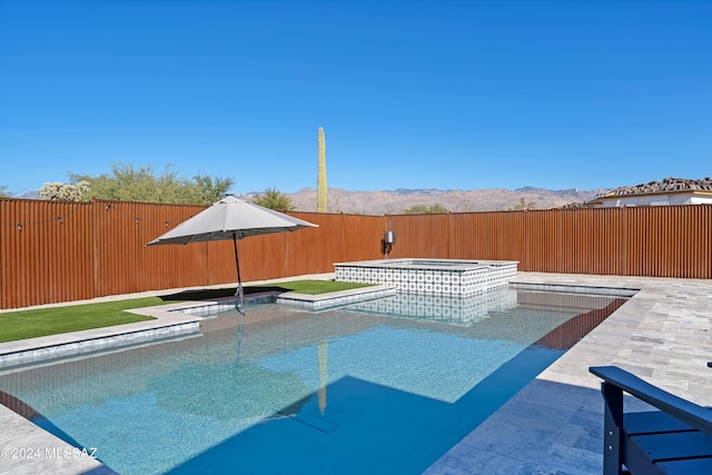 view of pool featuring a mountain view and an in ground hot tub