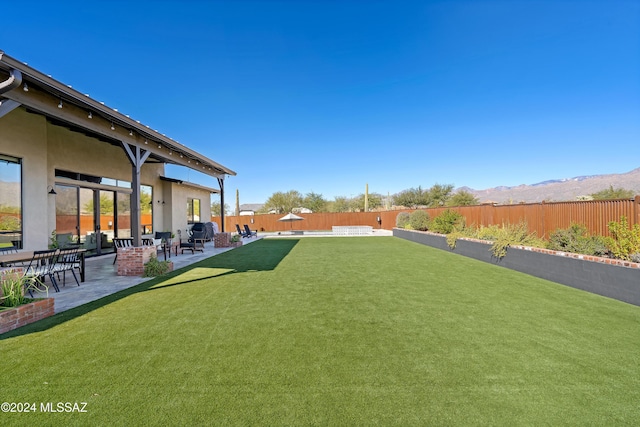 view of yard with a mountain view and a patio