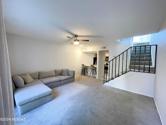 living room with carpet and ceiling fan