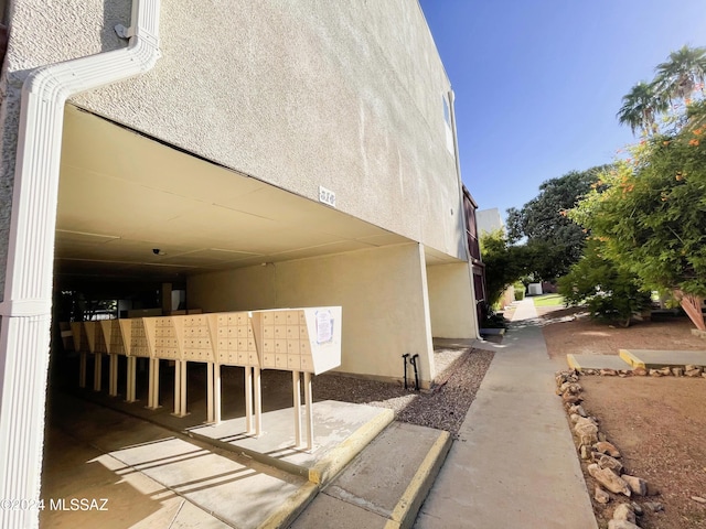 view of side of home with a mail area