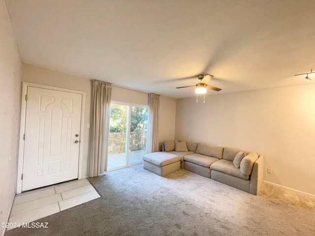 unfurnished living room featuring ceiling fan and light carpet