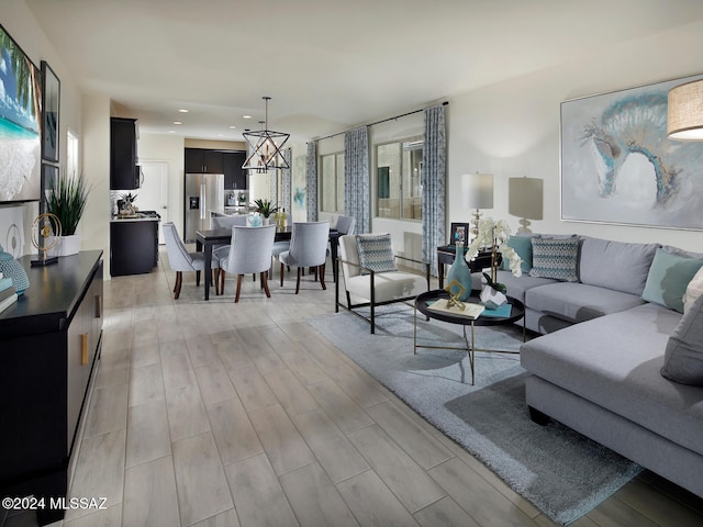 living room with a chandelier and light hardwood / wood-style flooring