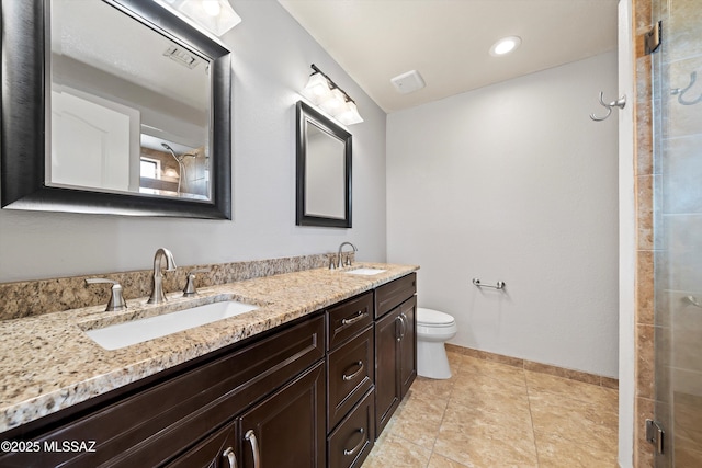 full bath with double vanity, a sink, toilet, and tile patterned floors