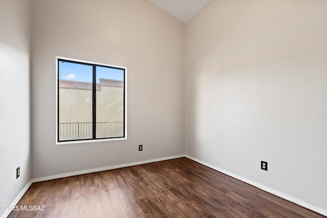 empty room featuring baseboards and wood finished floors