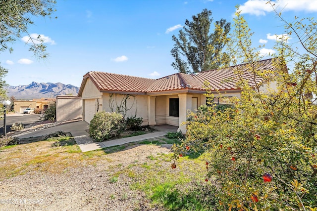 view of front of house featuring a garage and a mountain view