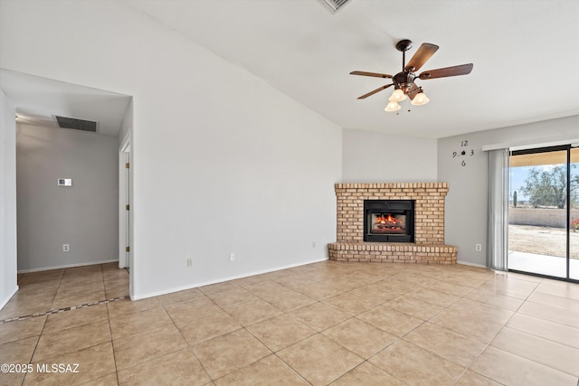 unfurnished living room with light tile patterned floors, baseboards, visible vents, a ceiling fan, and a brick fireplace