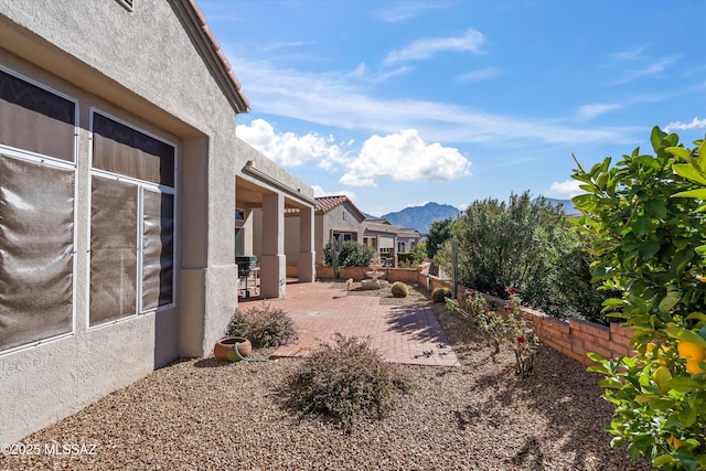 view of yard featuring a mountain view and a patio area