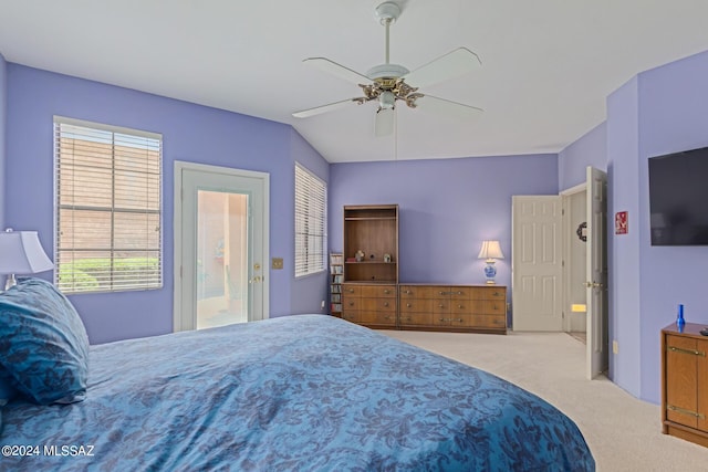 carpeted bedroom with ceiling fan and access to exterior