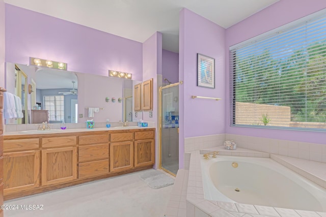 bathroom featuring ceiling fan, separate shower and tub, and vanity