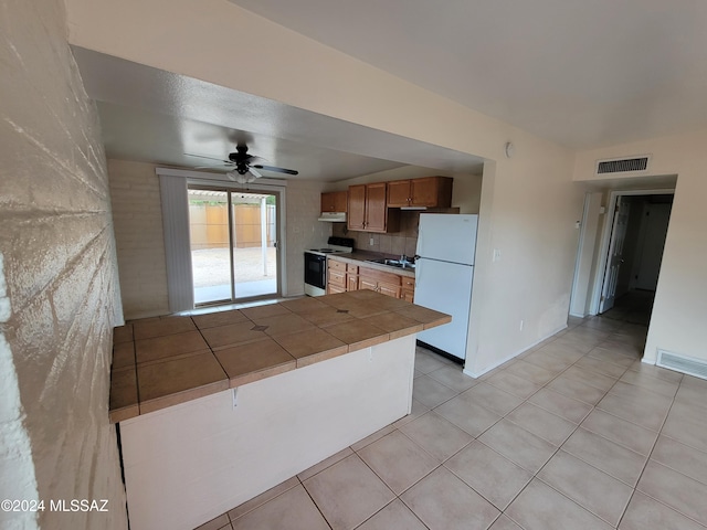 kitchen with ceiling fan, tile counters, kitchen peninsula, white appliances, and light tile patterned floors