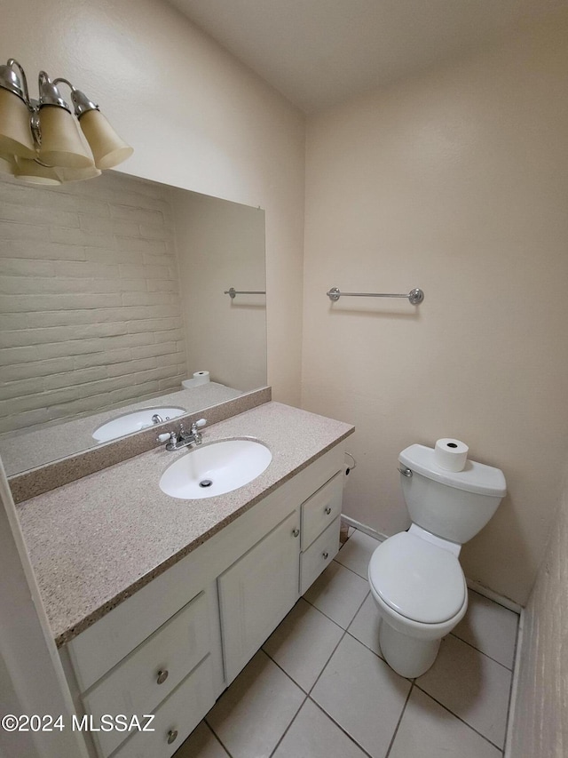 bathroom with tile patterned floors, vanity, and toilet