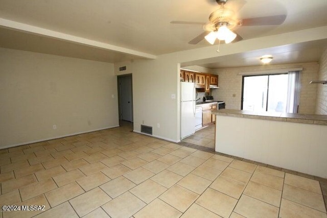 kitchen featuring ceiling fan and white fridge