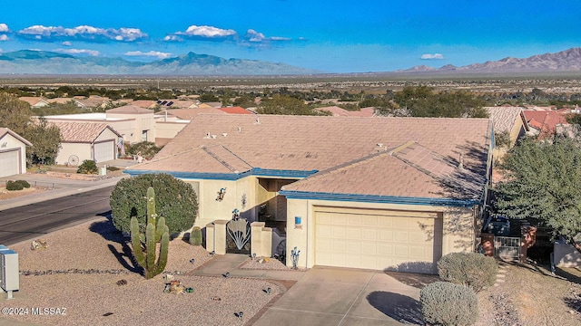 view of front of house featuring a mountain view and a garage