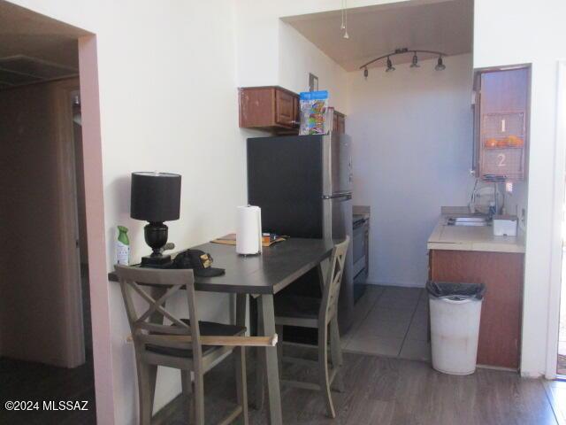 kitchen featuring sink, dark hardwood / wood-style floors, and stainless steel refrigerator