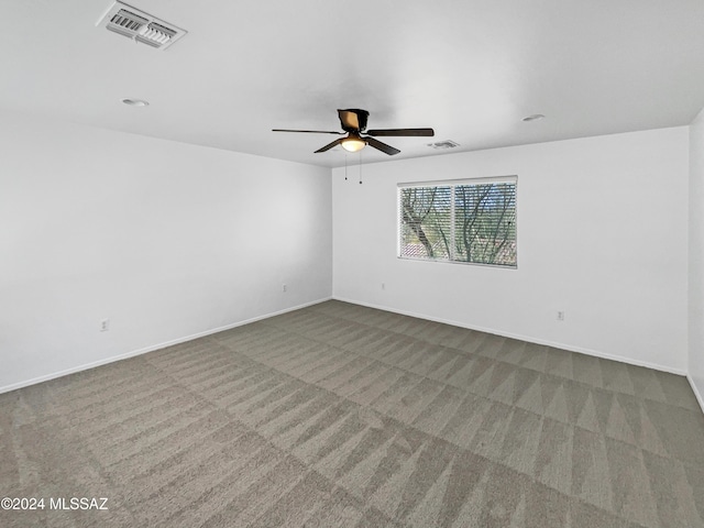 empty room featuring carpet flooring and ceiling fan