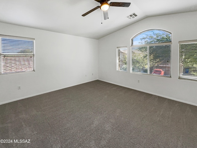 carpeted empty room with vaulted ceiling and ceiling fan