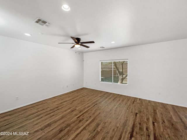 spare room with ceiling fan and dark wood-type flooring