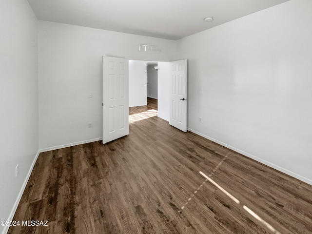 spare room with dark hardwood / wood-style floors