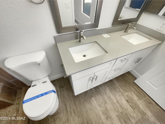 bathroom featuring hardwood / wood-style floors, vanity, and toilet