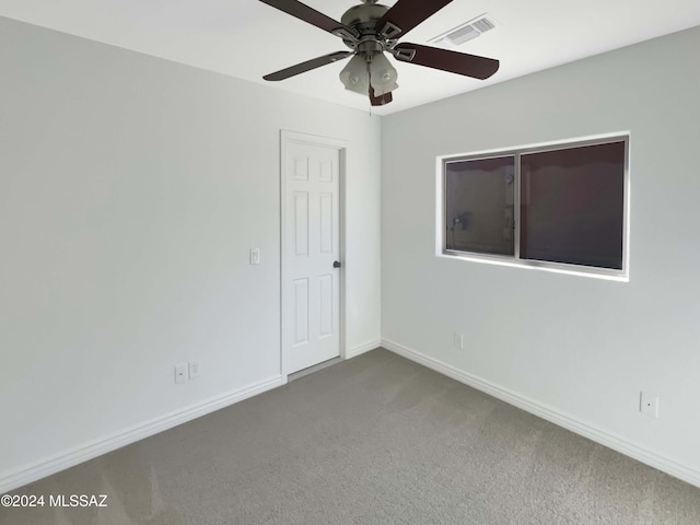 empty room with ceiling fan and carpet floors