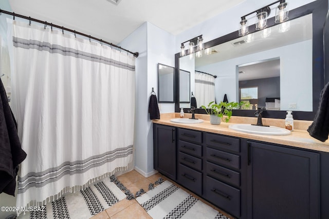 bathroom with tile patterned floors, curtained shower, and vanity