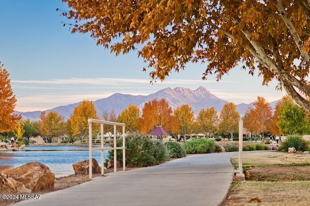 view of community with a water and mountain view