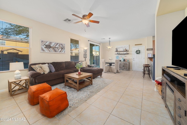 living room featuring ceiling fan and light tile patterned floors