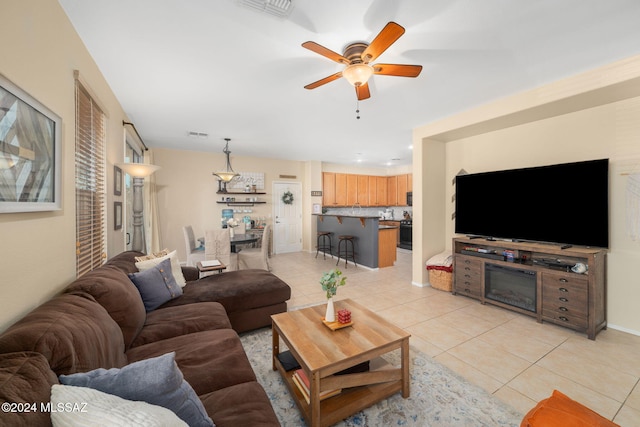 tiled living room featuring ceiling fan