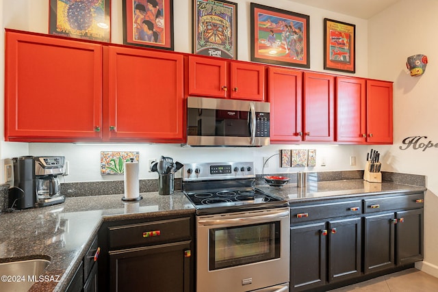 kitchen featuring light tile patterned floors and stainless steel appliances