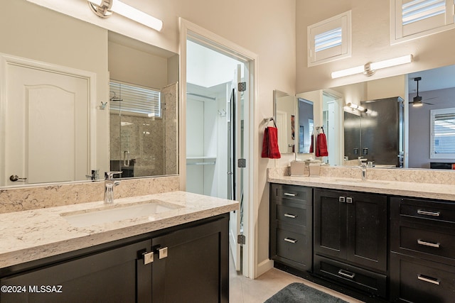 bathroom featuring vanity, a shower with door, tile patterned floors, and ceiling fan