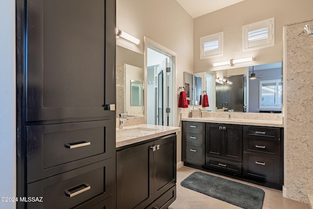 bathroom with tile patterned flooring, vanity, and ceiling fan