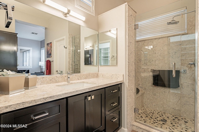 bathroom with vanity and an enclosed shower