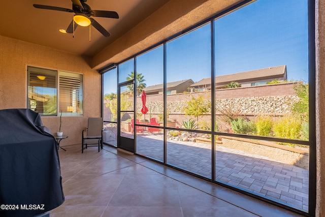 sunroom featuring ceiling fan