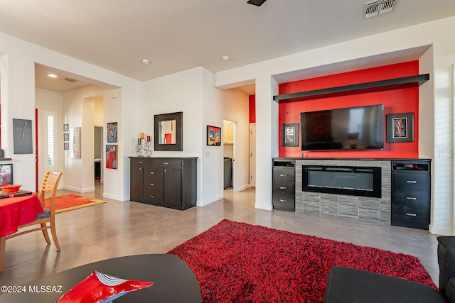 living room with a tiled fireplace