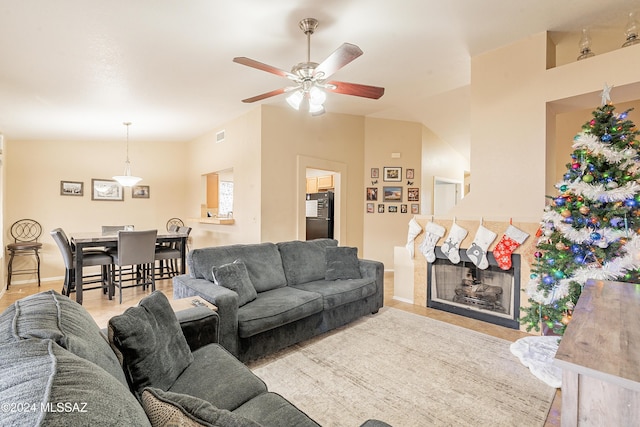 living room with vaulted ceiling and ceiling fan