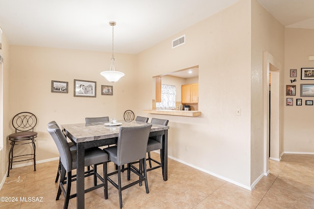 dining space featuring light tile patterned floors