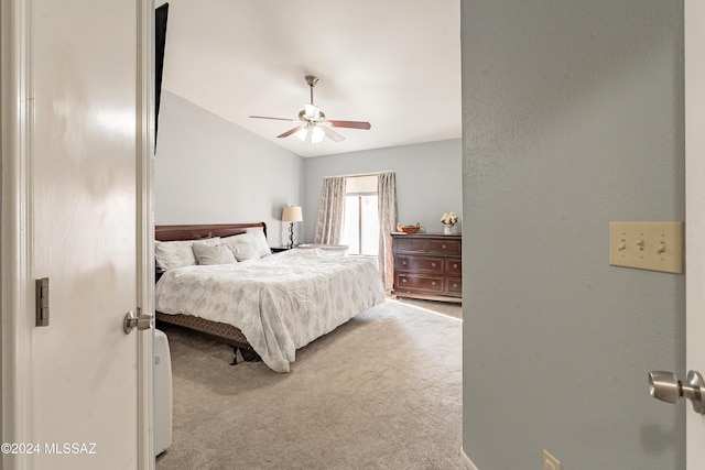 bedroom featuring ceiling fan, carpet, and vaulted ceiling