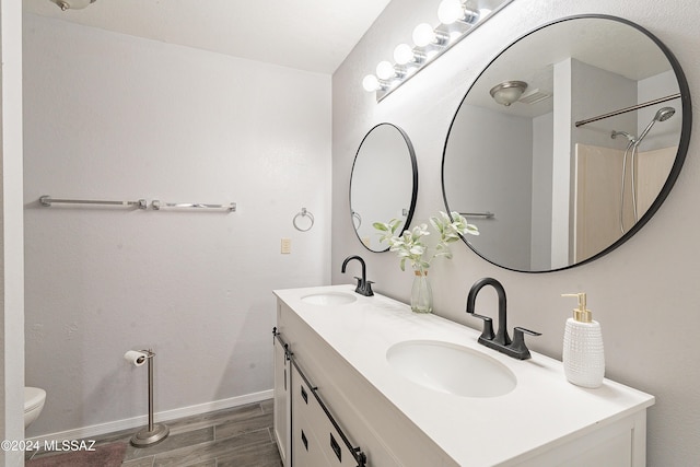 bathroom featuring hardwood / wood-style flooring, vanity, and toilet