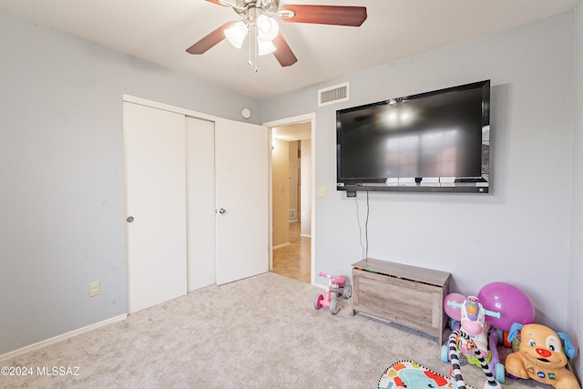 recreation room featuring ceiling fan and light colored carpet