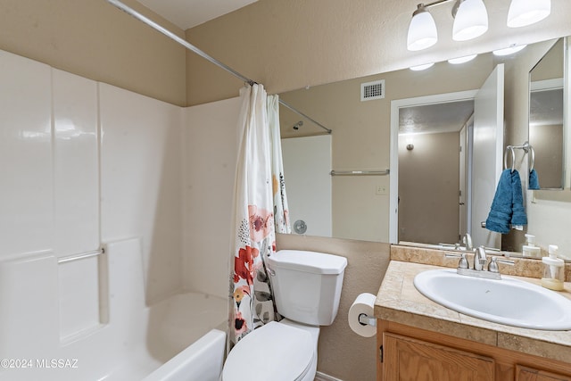 full bathroom featuring shower / bath combo with shower curtain, vanity, and toilet